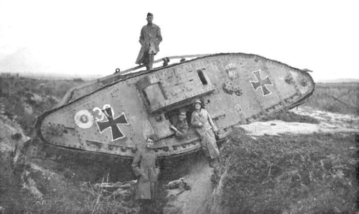 Art Bell and Leah with captured Mark IV tank in WW1 battlefield. Original caption "English tank - captured by Germans. Note - Bomb on ground. Hindenburg Line"