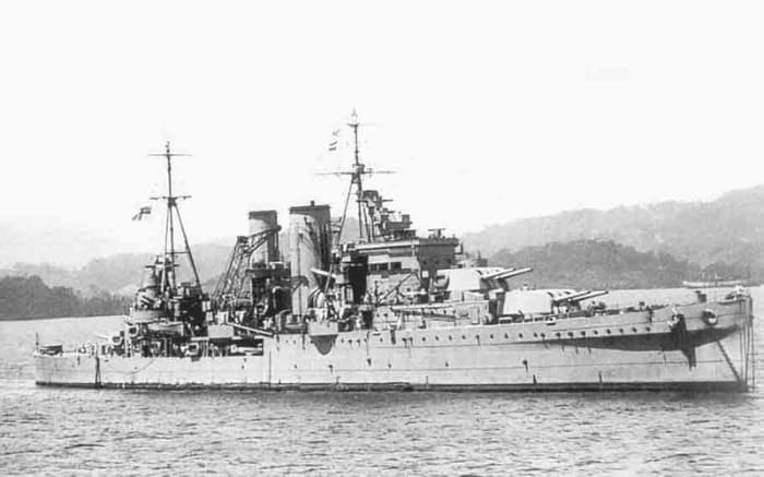 WW2: Heavy cruiser HMS Exeter was put out of commission by the Graf Spee. All three of her 8" turrets had been knocked out along with other significant damage. 61 officers and ratings were KIA. Image shows HMS Exeter off the coast of Sumatra (Netherl