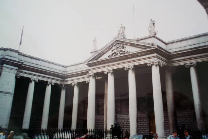The House of Commons entrance of the former Irish Houses of Parliament. Note the Ionic columns, dentil molding, and pediment with high relief sculpture.
