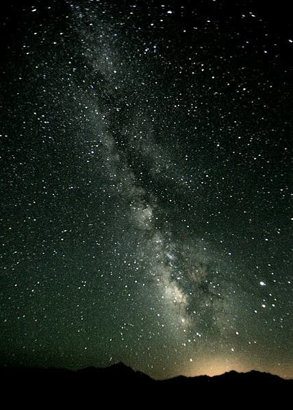 The Milky Way often shows a dark band dividing the hazy light band - a dark nebulous cloud similar to that found in some other galaxies and shown in the image of NGC 4565 in the previous section