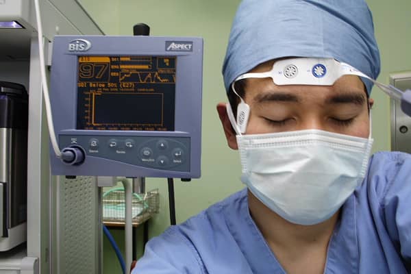 Demonstration of a BIS monitor. This "patient" is fully conscious as demonstrated by the number "97" on the monitor behind him.