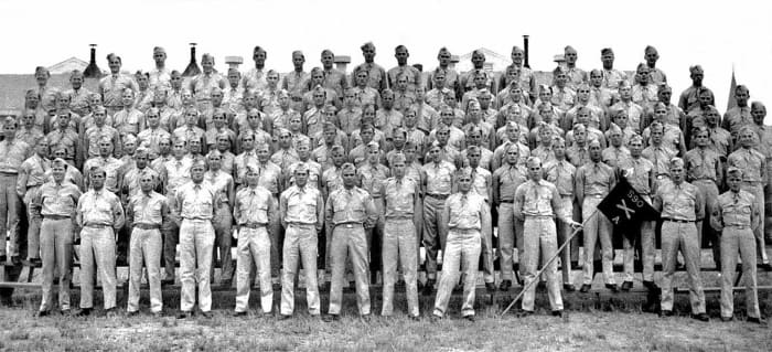 A Battery, 590th Field Artillery. The entire battery was either captured or killed. The CO, Captain Pitts (front row, center) was killed on Dec. 16. Another officer, Lt. John Losh (next to flagbearer) was killed in captivity.