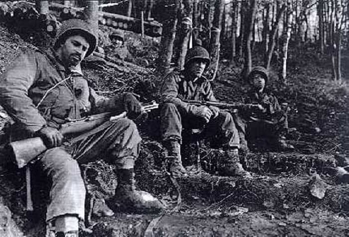 One look says it all: Grim GIs from the 8th Infantry Regiment of the 4th ID taking a break in the Huertgen. They appear to be wearing overshoes, which helped a lot in keeping their feet warm and dry. Those would become in short supply by winter.