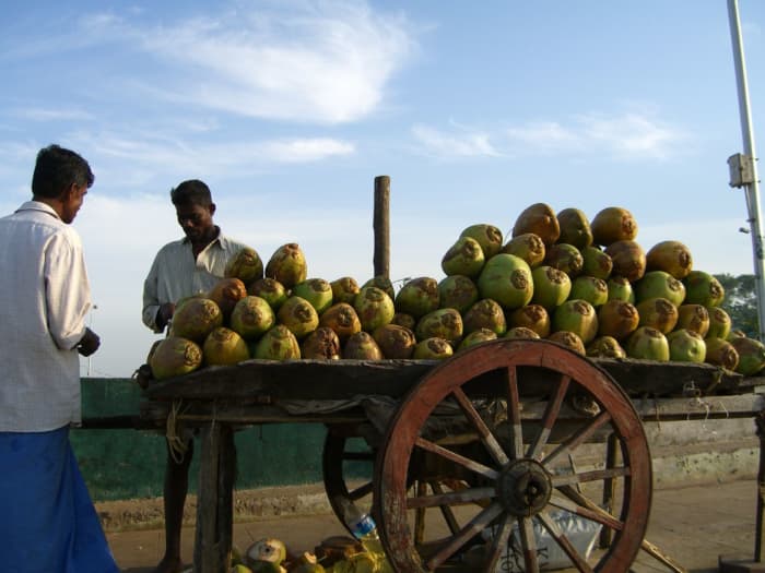 having a refreshing coconut water is as easy as buying a coconut fresh from a local seller and sticking a straw in it.