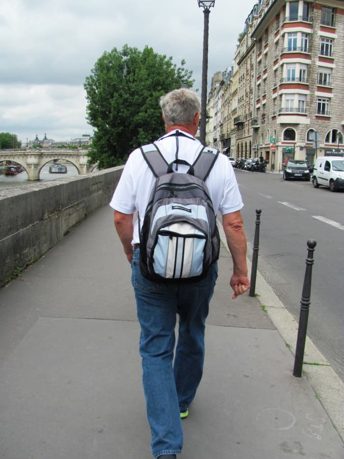 My dad walks alongside the River Seine in Paris near the location of the French National Police on the Ile de la Cite.