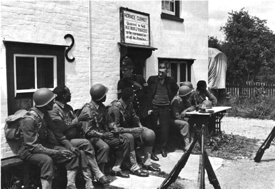 Black troops enjoying hospitality in the UK. Relations were good between the British public and Black Americans.