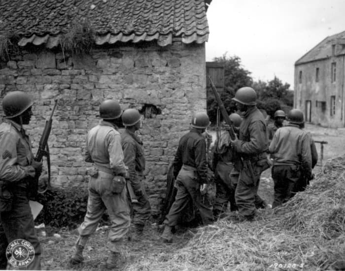 A group of support troops go hunting for a sniper, June 10, 1944, Vierville-sur-Mer, France (near Omaha Beach)