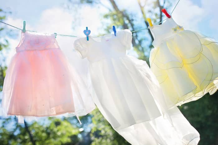 Hydrogen peroxide is usually a better bleach for coloured fabrics than sodium hypochlorite because it's less likely to remove the colour.