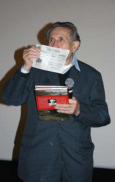 Adolf Burger at the 2008 premiere of "The Counterfeiters." He's holding up one of the fake banknotes.
