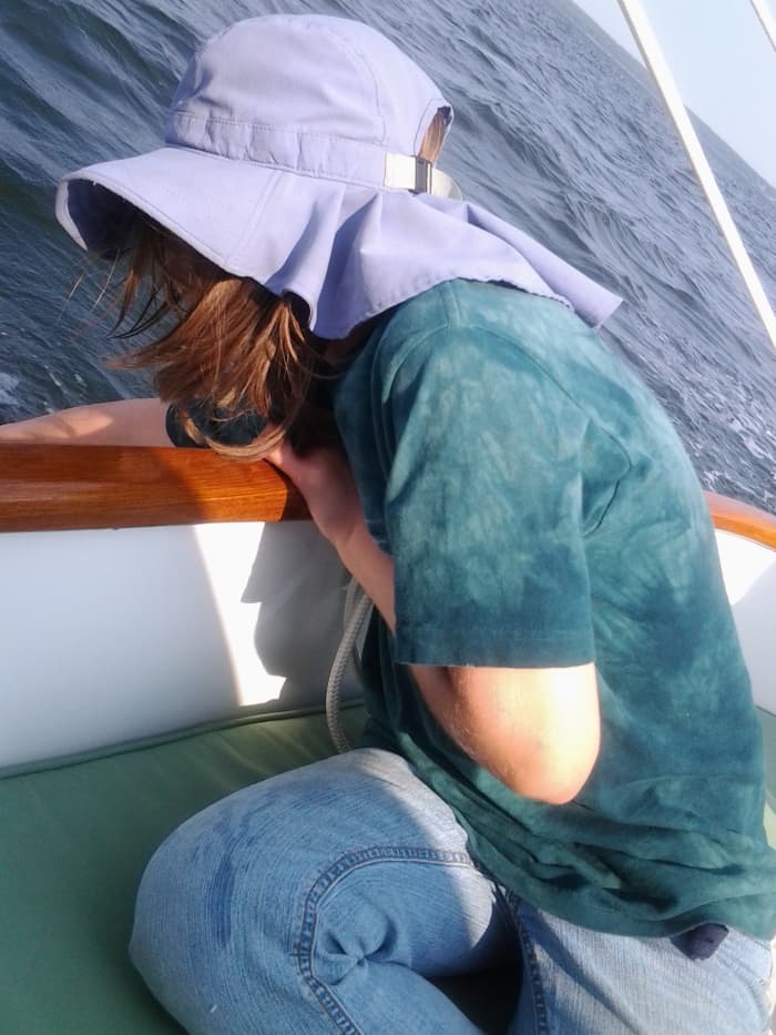 My daughter loves to touch the surface of the water when we are under sail in our neighbor's boat.