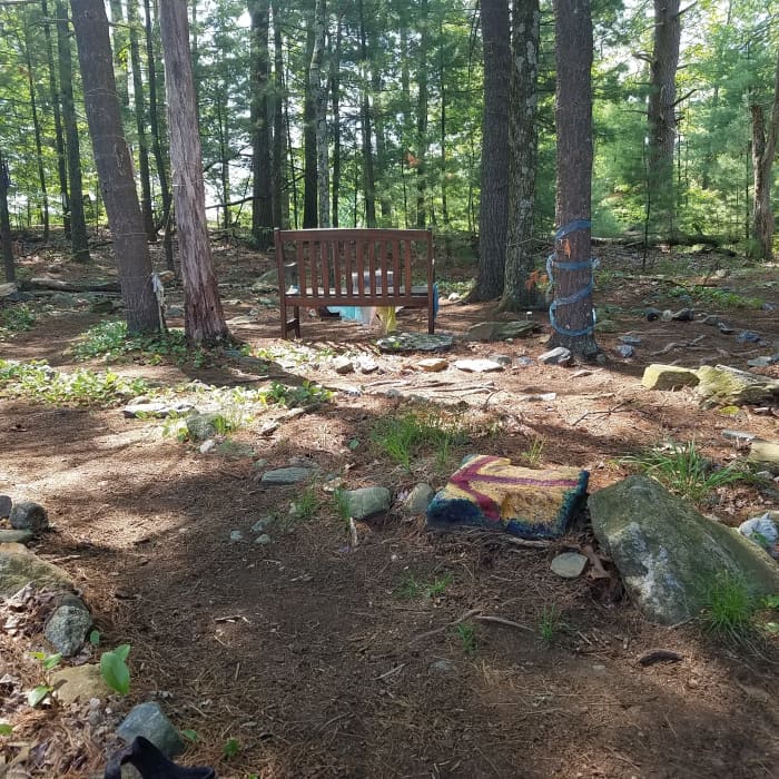 The arrow rock I painted at the entrance of the labyrinth I walk daily when the weather in New England permits.