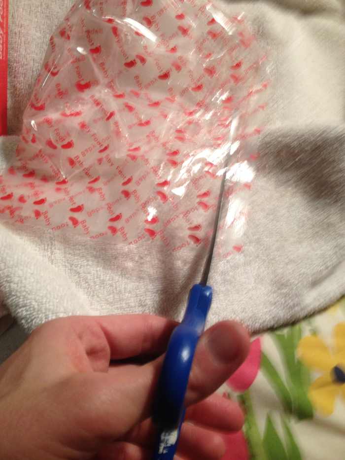 Cutting the top off of the Baby Foot plastic sock.