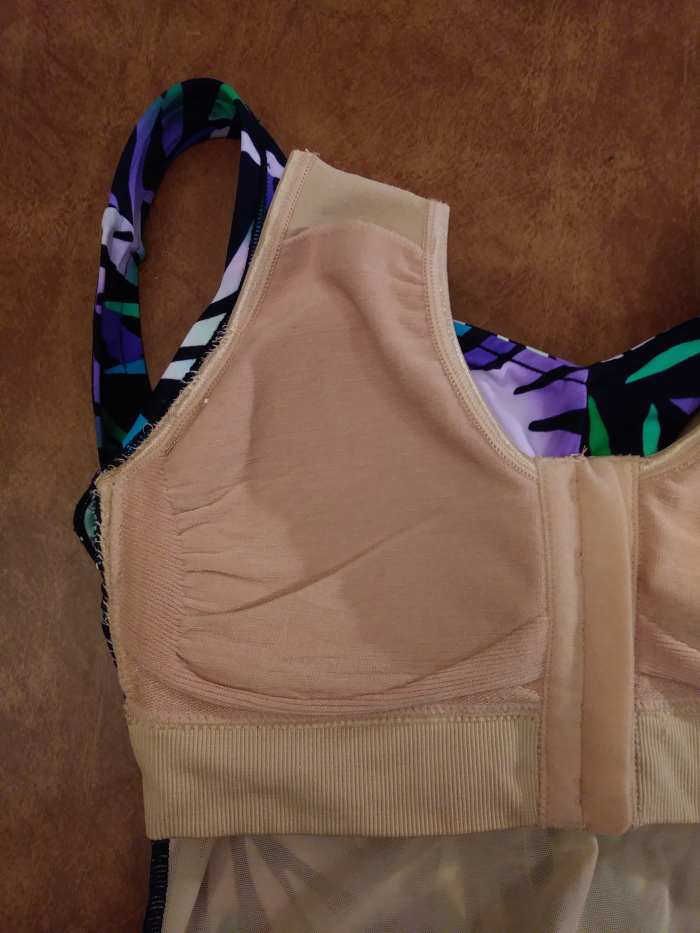 The armhold edge is sewn to the suit.