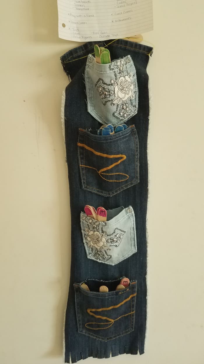The chore stick organizer! Made from old jeans that were falling apart, these jean pockets hold each day's chore selections.