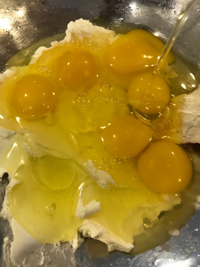 Beat together the cream cheese and the eggs. It really helps if the cream cheese is softened at room temperature. This mixture will be lumpy, and that's fine.