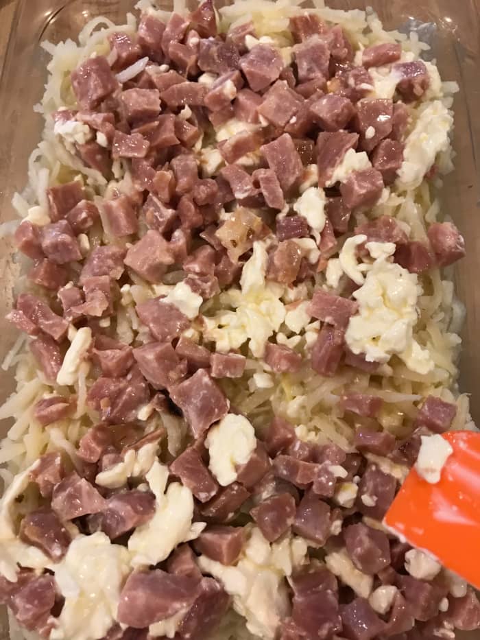 Pour mixture into the buttered casserole dish. If needed, redistribute the ham a bit to make it even.