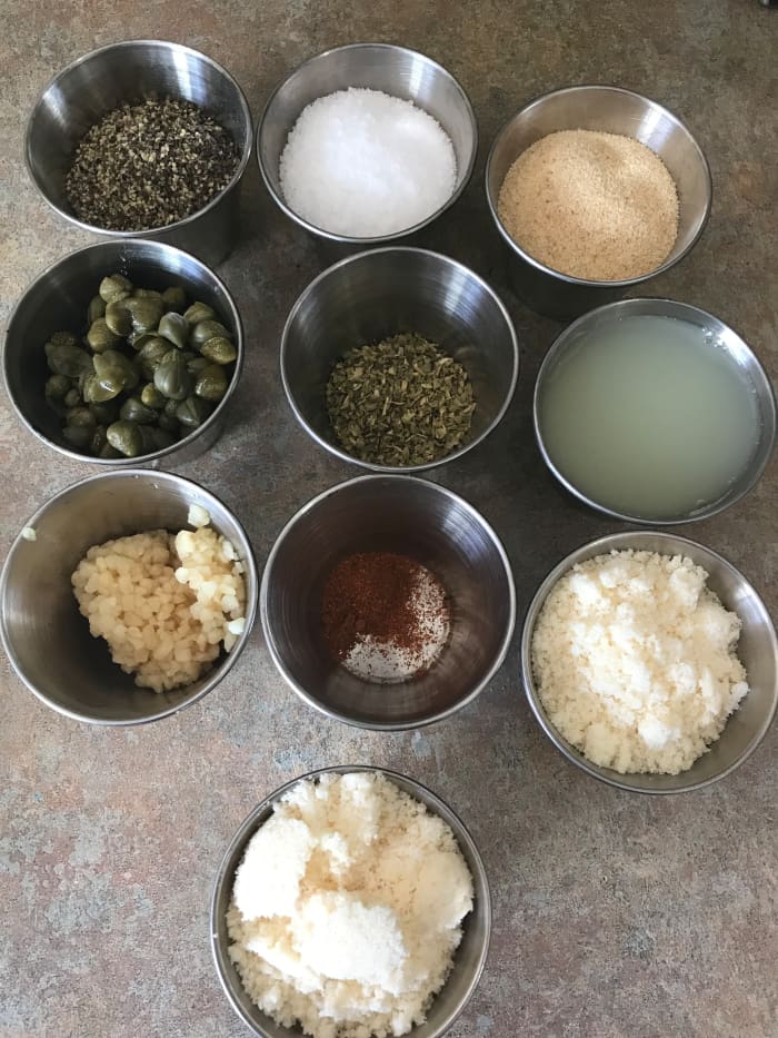 This recipe calls for simple seasonings: kosher salt, black pepper, garlic powder, garlic, oregano, capers, cayenne, lemon juice, and Parmesan cheese.