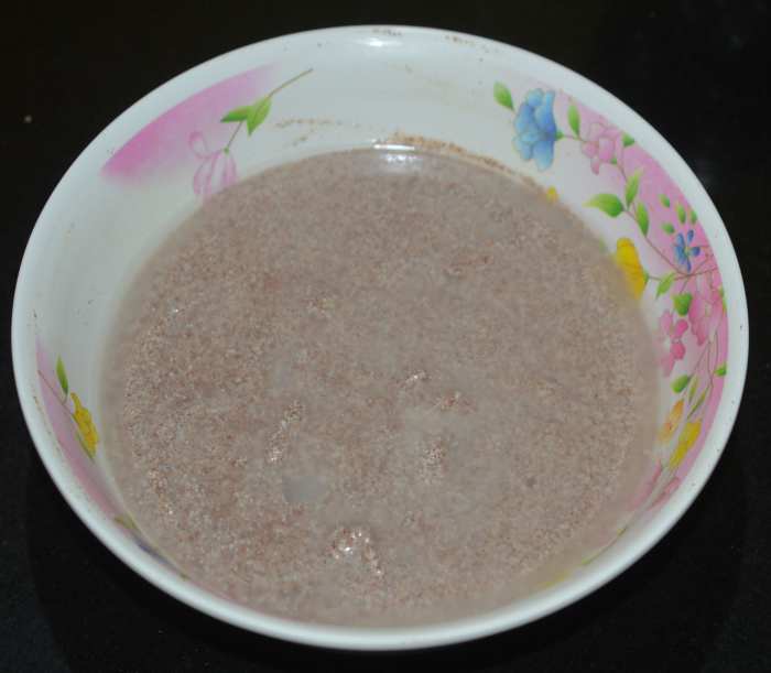 Add water and mix well to get an idli batter consistency. Cover and allow it to rest for 5 minutes.