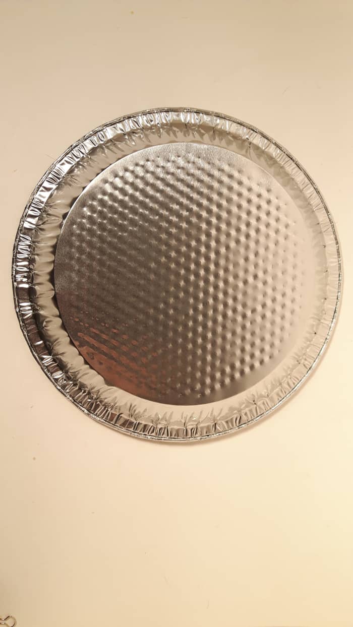 An upside down pie plate. The sides of the pie plate could alter how the cookies bake so turn it upside down.