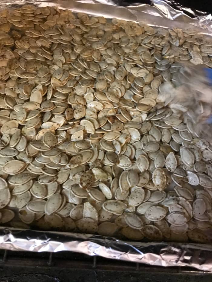 About half an hour should do it - you're looking for bits of the seasonings to get very dark golden - but not black! At the end, keep a close eye on the pumpkin seeds. Golden is wonderful - but burnt is burnt.