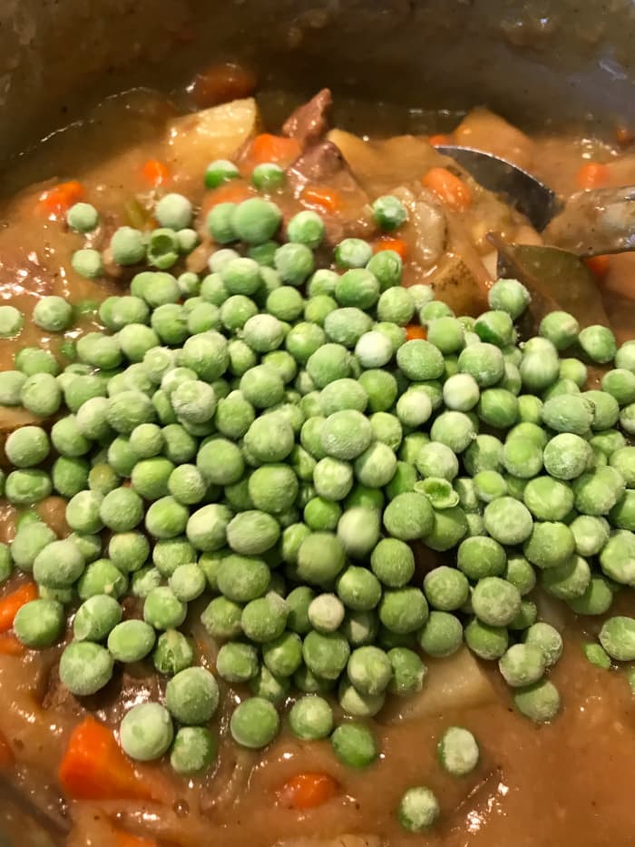 I wait until the last minute to add peas - you can use fresh or frozen. I always have frozen peas. I really only let the stew warm the peas through. They stay nice and crisp, giving a beautiful contrast to the richness of the beef and sauce.