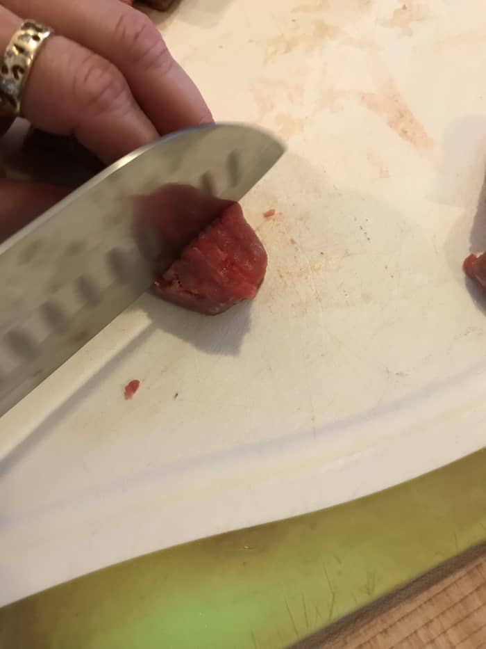 Whole beef chuck is usually less expensive than buying precut stew beef, but not always, so check the per pound price. I like smaller bites, so I cut it into 1 or even 1/2 inch cubes before seasoning and flouring.