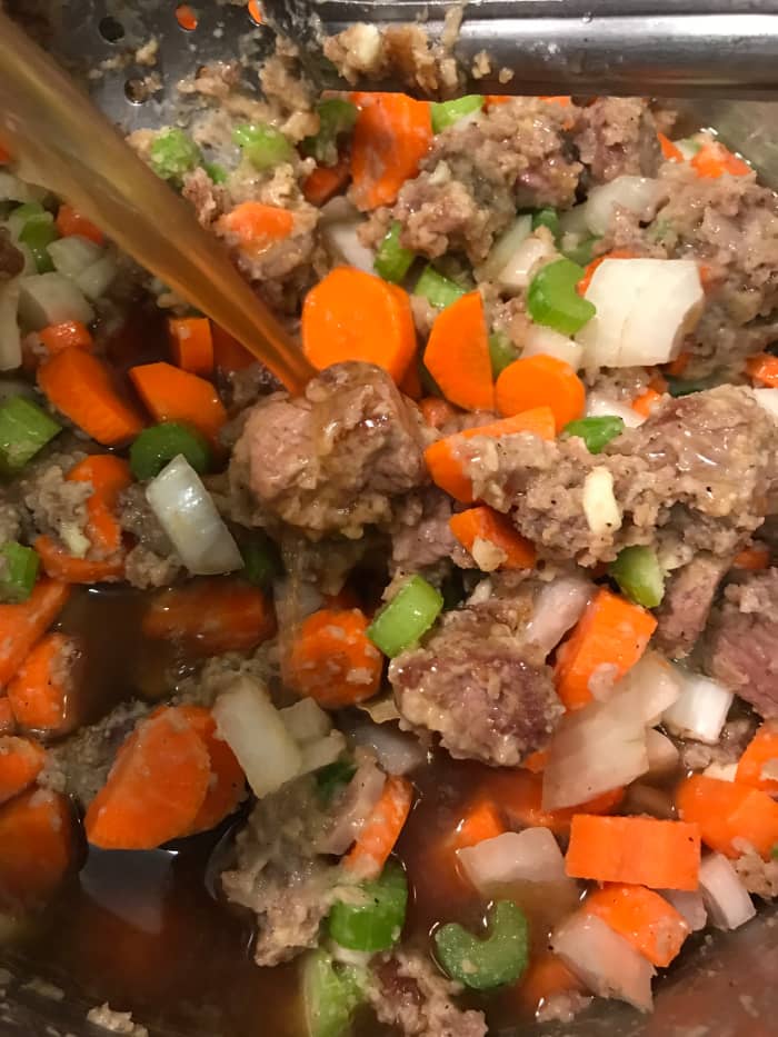 You can transfer the beef stew to a slow cooker at this point if you like. Then add the wine and beef stock. You can use red or white wine - it's to boost flavor and add a hint of acid, but not a dominate flavor by itself, so it's whatever you have.