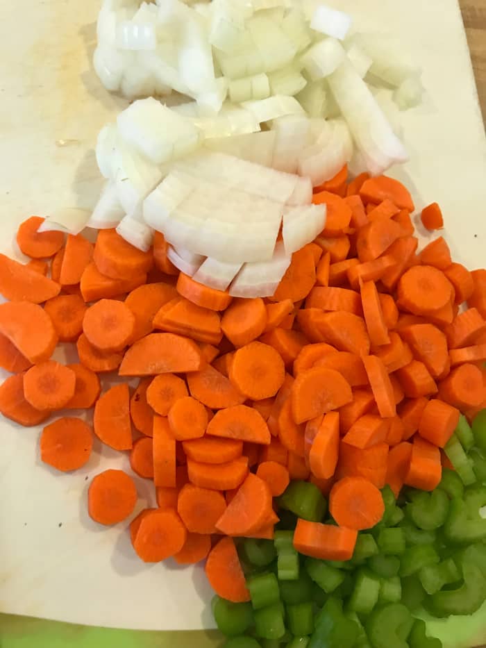 While the beef is browning, prep the veggies. I like carrot, onion and celery for simplicity.They highlight the beefy flavors beautifully. You can choose your favorites though - just pick vegetables that can handle long cooking.