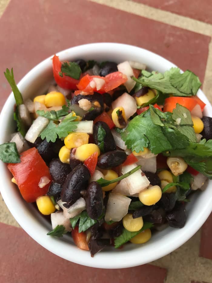 This stuff is amazing. I'm always looking for ways to get more fresh veggies into my kids, and I adore recipes that they love as much as I love the nutrition. This fresh black bean salsa is the perfect way to do that.