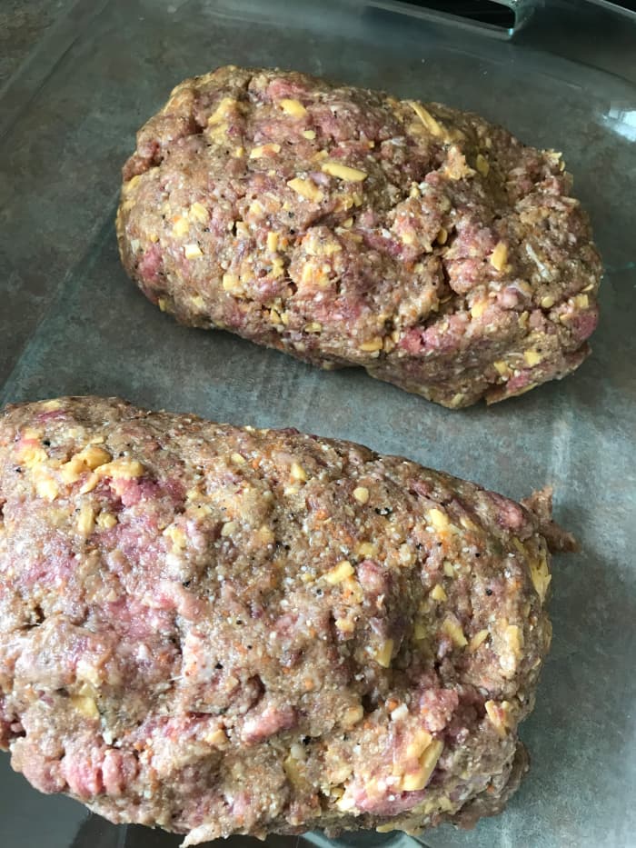 Place the shaped meatloaves onto a rimmed baking sheet or into a 9x13 baking dish. If desired, freeze any number of meatloaves at this stage by wrapping tightly in plastic wrap.