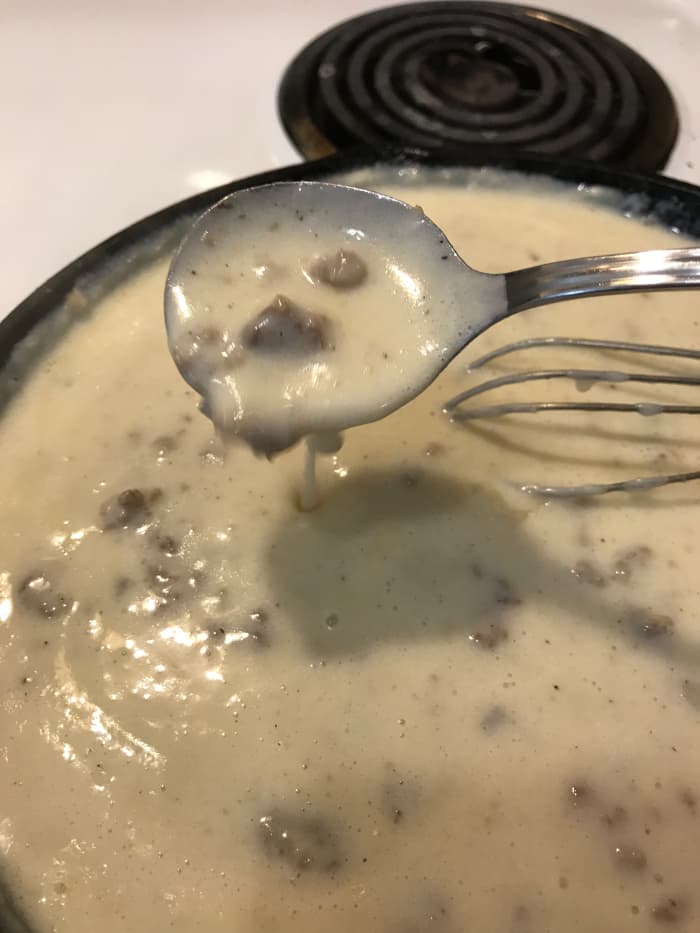 When it has simmered for at least a minute and has thickened. See how it coats the spoon in this picture? That's just right. It will also continue to thicken as it sits, so if you like it thicker, just wait a minute. If you can ;-)