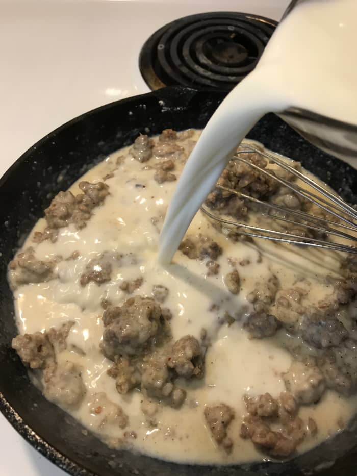 Once you've added about a cup of the milk, add the remainder in a steady stream, whisking constantly. Bring the sausage gravy up to a boil, and reduce to a simmer.