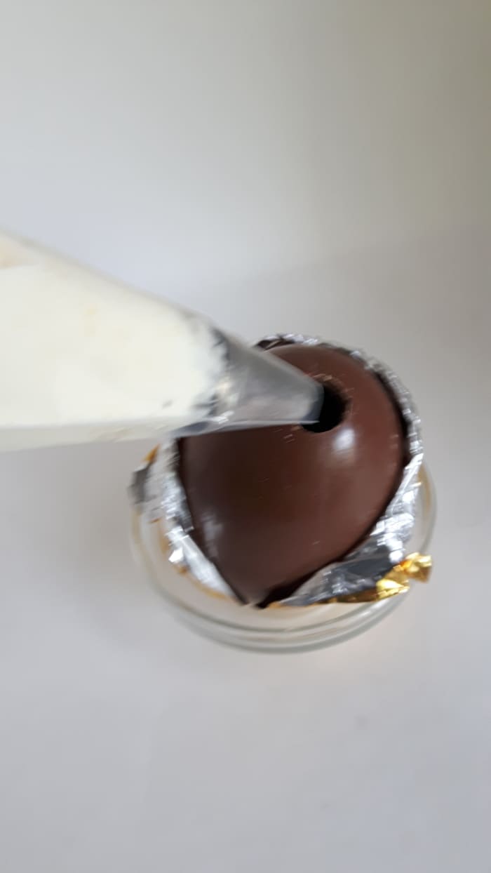 Step 9: Use a piping bag (or a plastic bag with the corner cut out) to put the pineapple mousse into the egg.