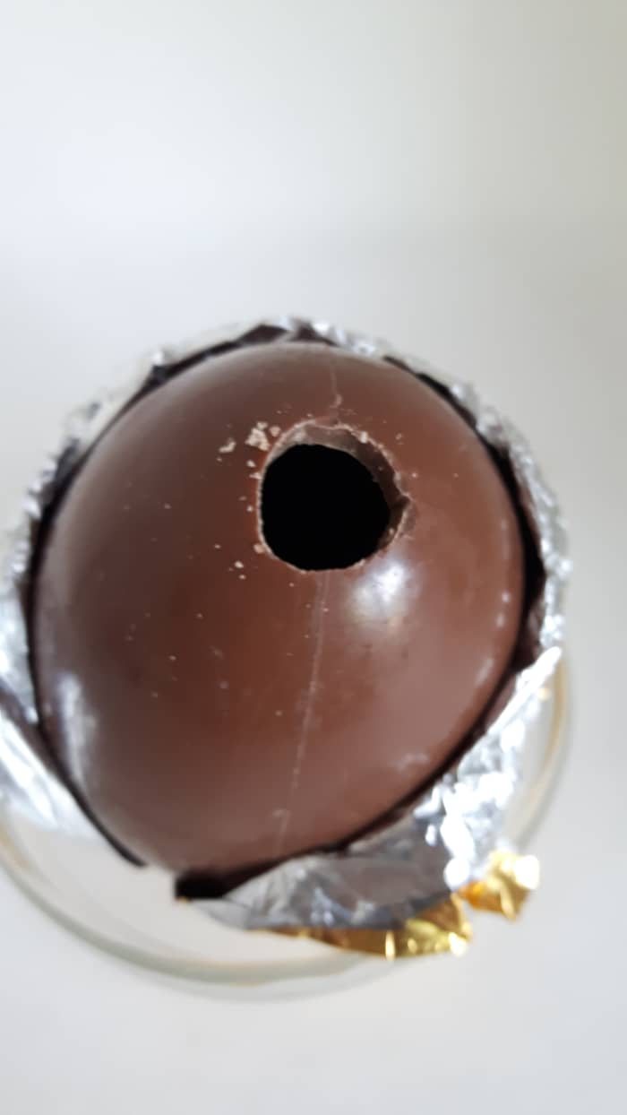 Step 8: Use a sharp pointed knife to drill a small hole in the top of the egg. Make the hole bigger by rotating the knife.
