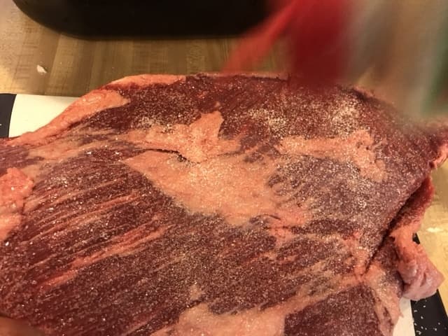 You'll need to season both sides of the brisket heavily with kosher salt, black pepper and garlic powder.