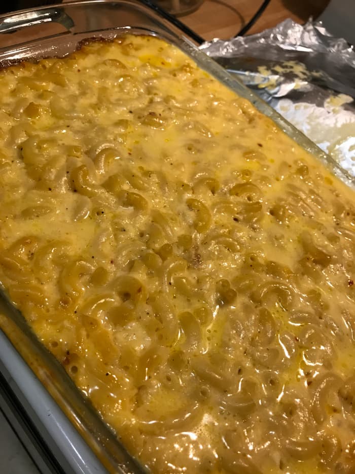 The baked macaroni and cheese hot out of the oven. If you serve it immediately, it will be a little bit loose. If you let it rest for about 10 minutes, it'll tighten up. Either way, it's molten hot - so be careful!