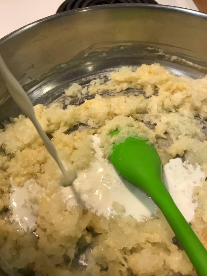 Add the milk, a little at a time, stirring well after each addition. This helps keep the sauce nice and smooth, and without lumps. Once you've added about 1/3 of the milk, go ahead and just add the rest, stirring well.