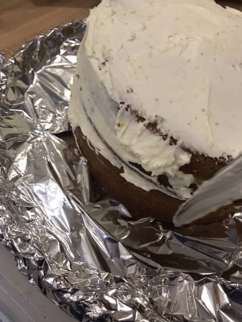 Apply a super thin coat of the lemon butter cream as a crumb coat. It doesn't have to be pretty - it's to make the final frosting look gorgeous. Chill again after the crumb coat.