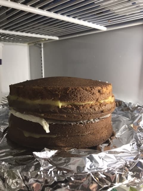 Letting the cakes chill thoroughly helps set the buttercream in the center, and the lemon curd as well. Give them an hour or two in the fridge, and the crumb coat will be easier to apply.
