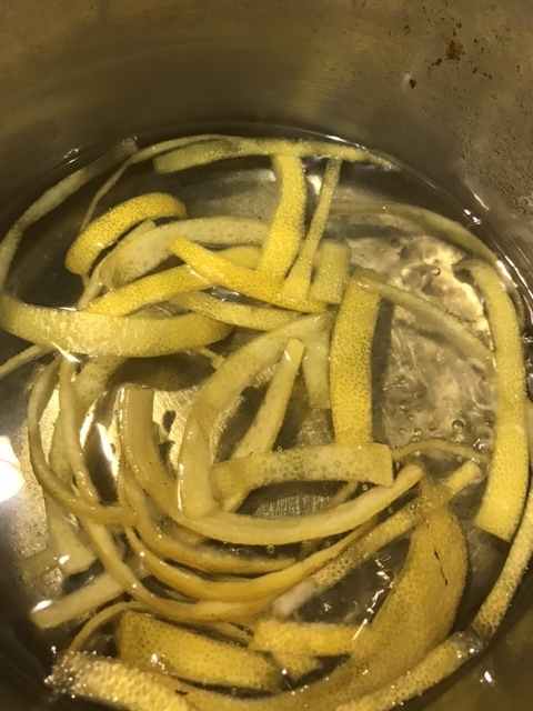 Bring the lemon peel, sugar and water to a boil, reduce to a simmer, and simmer for about 20 minutes. It'll depend a bit on how thick yours is cut, but you're looking for the lemon peel to turn translucent.