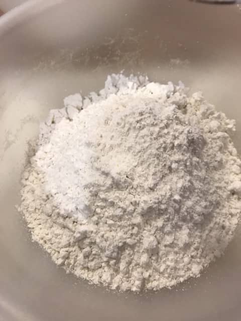 Stirring together the dry ingredients in a separate bowl helps make sure there's an even distribution of them in the finished cookie dough, without overworking the gluten, which could make the cookies tough.