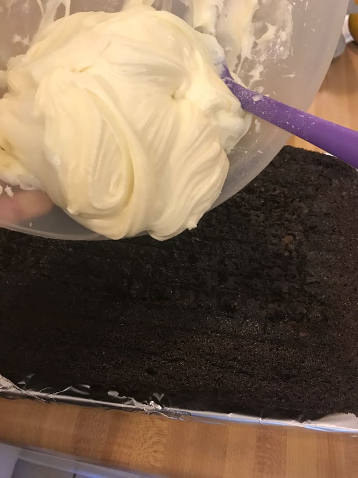 Once cooled, spread the frosting evenly over the top of the chocolate cake. You can frost the top only, or the top and sides, whichever you prefer.
