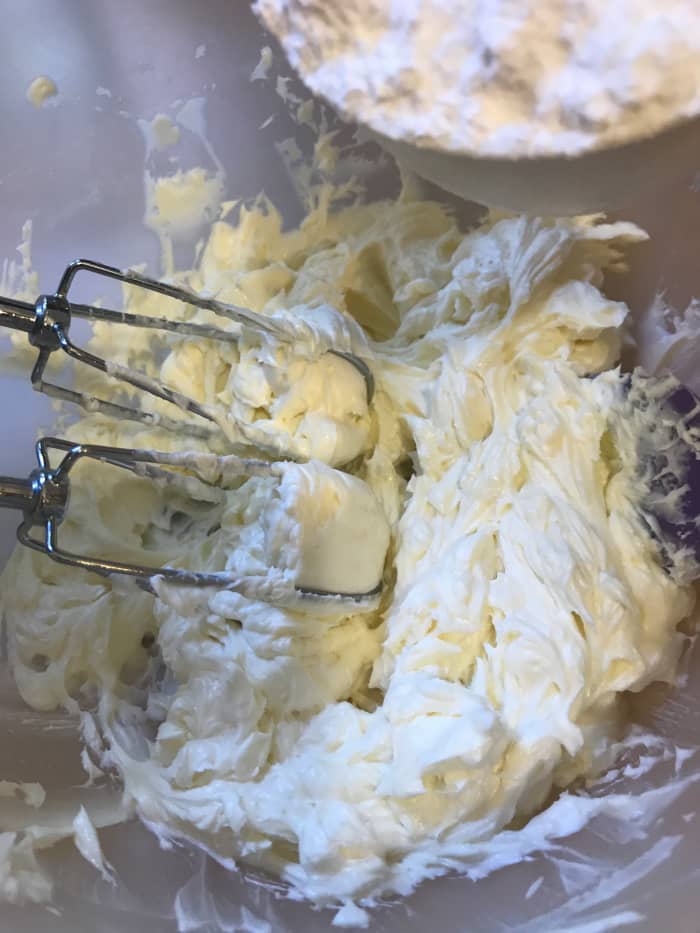 Add 2 cups of powdered sugar and a teaspoon of vanilla extract and mix well. Scrape down the sides of the bowl as you work, and mix until smooth. It's ready to use!