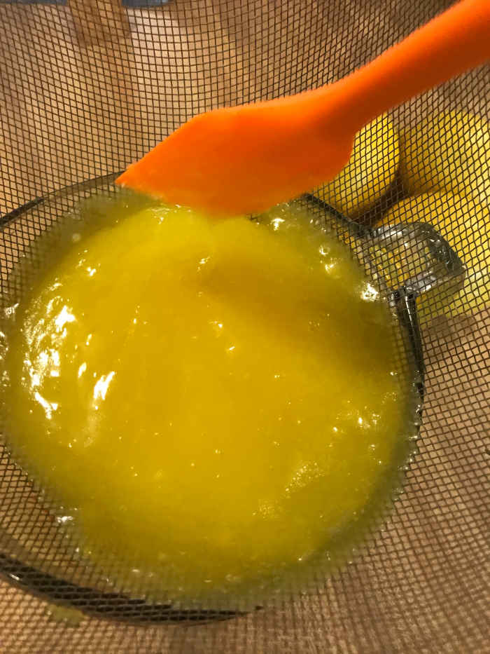 Strain the lemon curd, working it through the fine mesh of the strainer with a plastic spatula. The resulting lemon curd will be super silky!