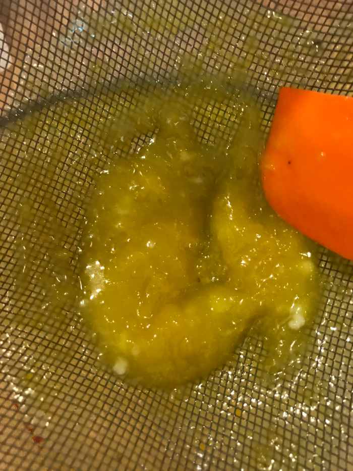 Most of what you're straining out is lemon pulp, but you also make sure you have no stray lemon seeds in the finished lemon curd. You also catch little bits of coagulated egg white. Get rid of that!