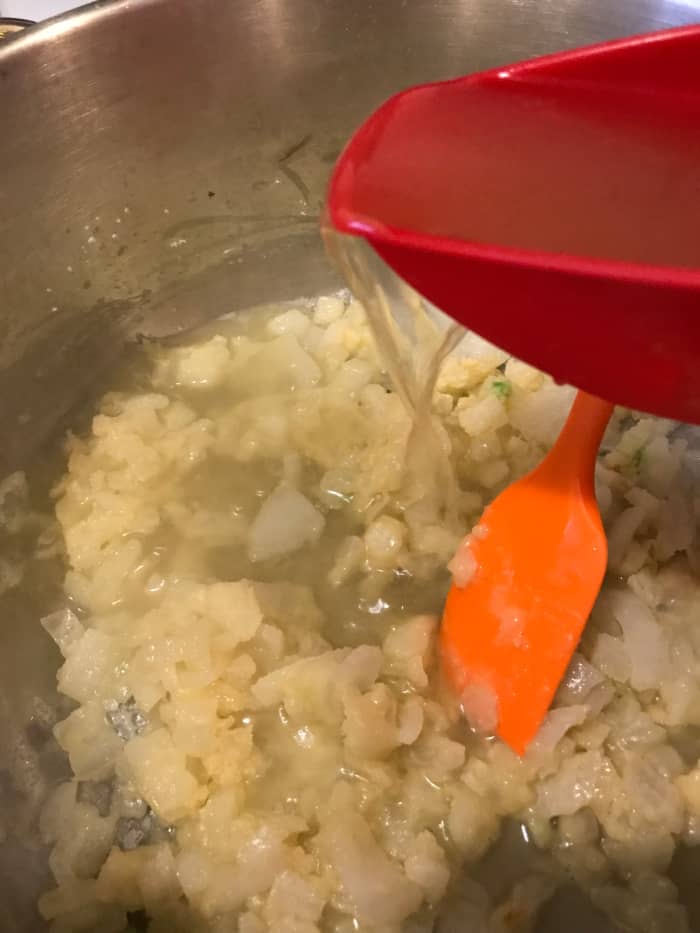 Whisk the flour into the butter and onion mixture, stirring constantly to incorporate the butter and flour fully. This will thicken the soup. Add the broth slowly in small batches, stirring between each, to avoid lumps.