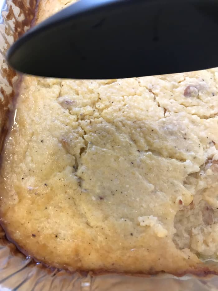 The bacon and cheese grits are done when the edges are set, the dish is bubbly throughout and the top is golden brown.