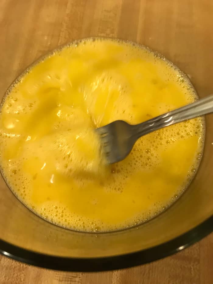 Beat two large eggs in a small bowl. Stir these into the creamy cheese grits off the heat. This gives the dish some rise - almost (but not quite) like a souffle.
