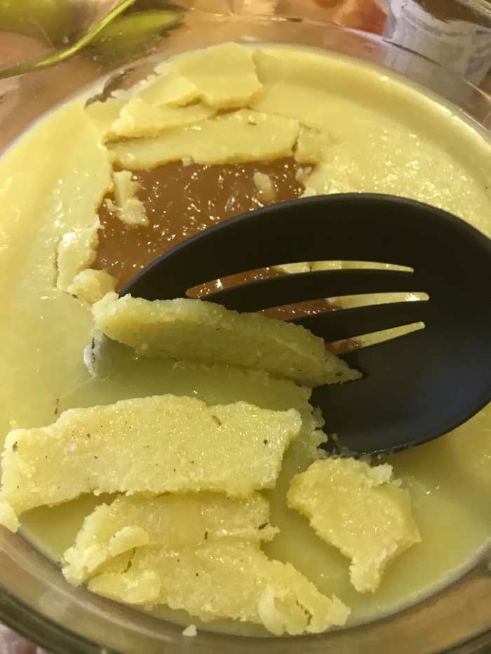 Once the broth has chilled thoroughly, the fat will solidify in an even layer on the top. Simply lift it off - it will separate easily and you can toss it.
