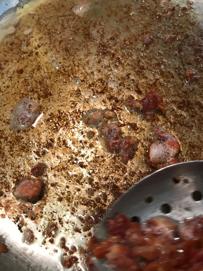 Set the rendered bacon aside, and pour off almost all of the grease. You'll be working in the same skillet, capturing the fond left behind, so the grease really isn't necessary. You'll get plenty of flavor without the majority of it!